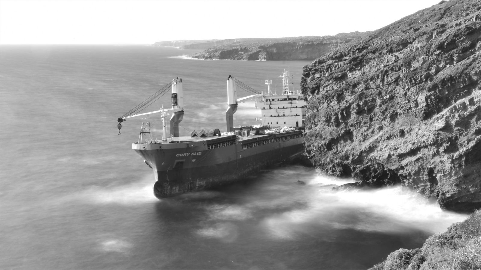 Ship stuck on rocks in ocean