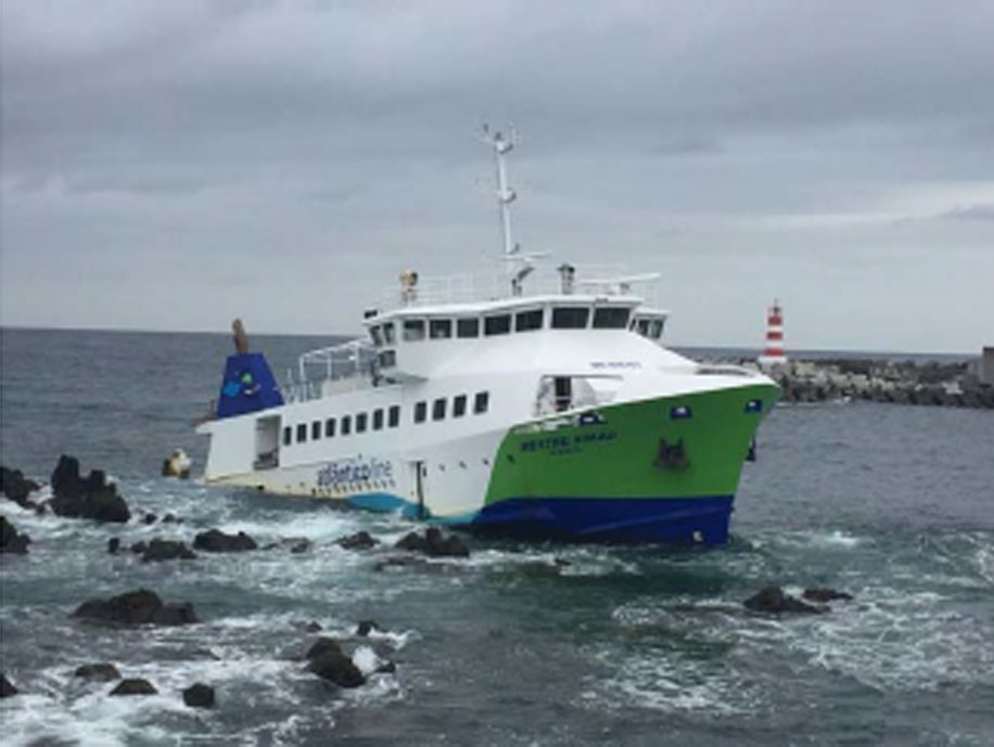 A sinking ship near rocks